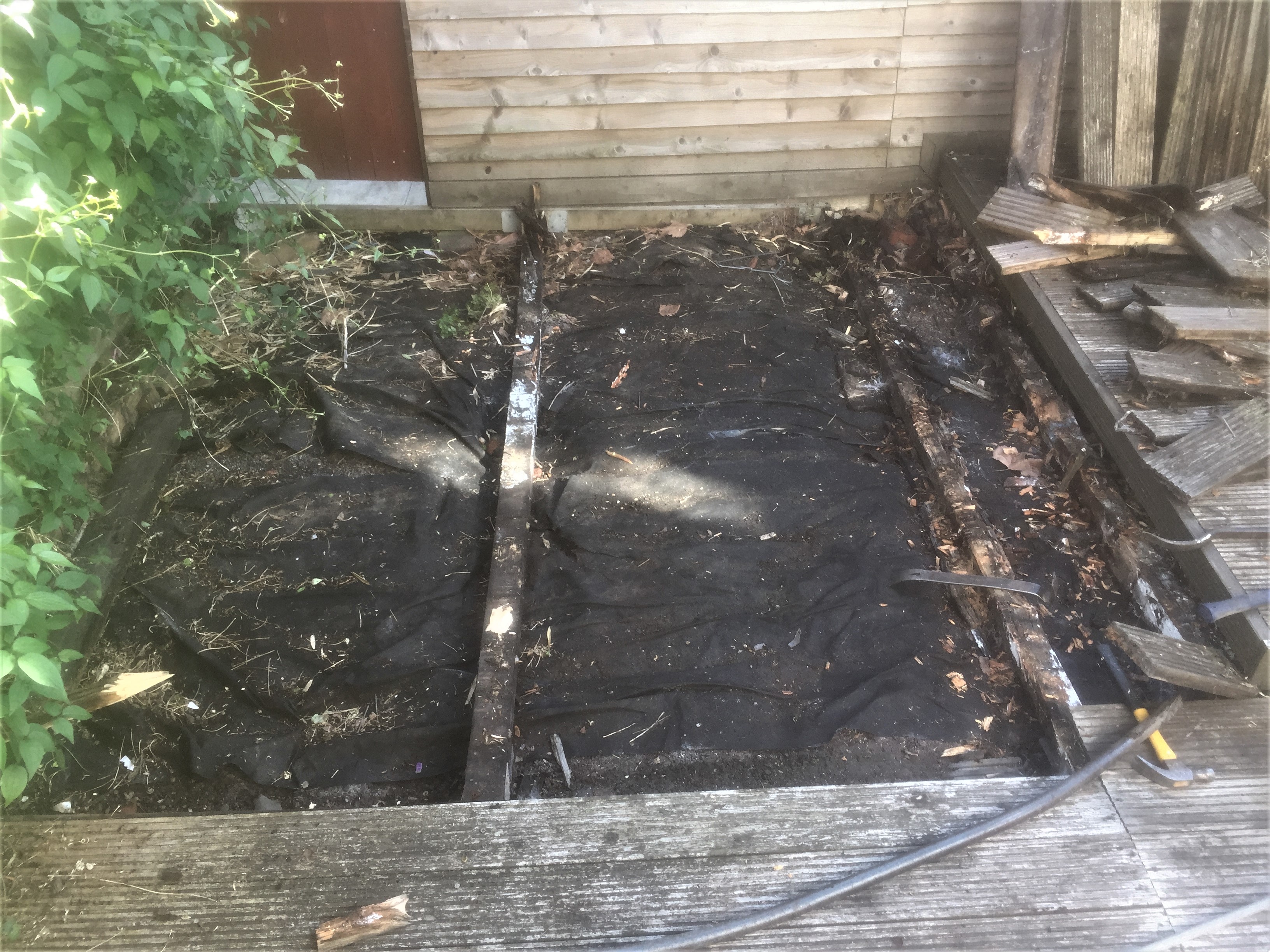 Rotten decking beams sitting directly on soil